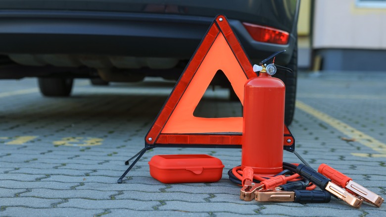 Emergency kit items behind a car