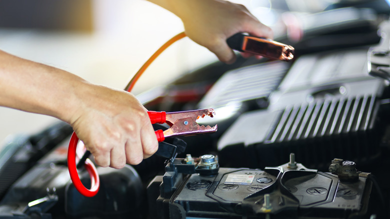 Jumper cables being attached to battery