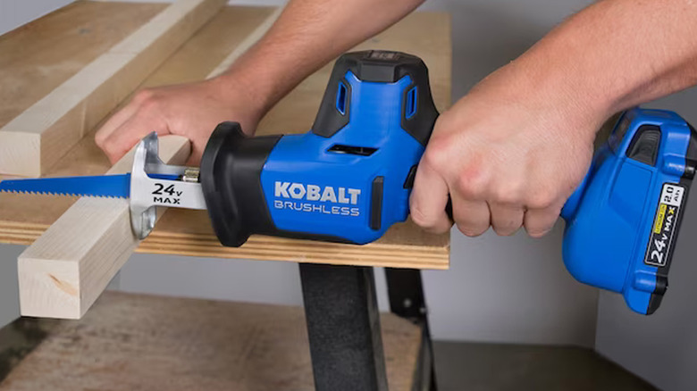 person using kobalt reciprocating saw