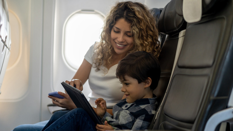 kid using ipad on plane