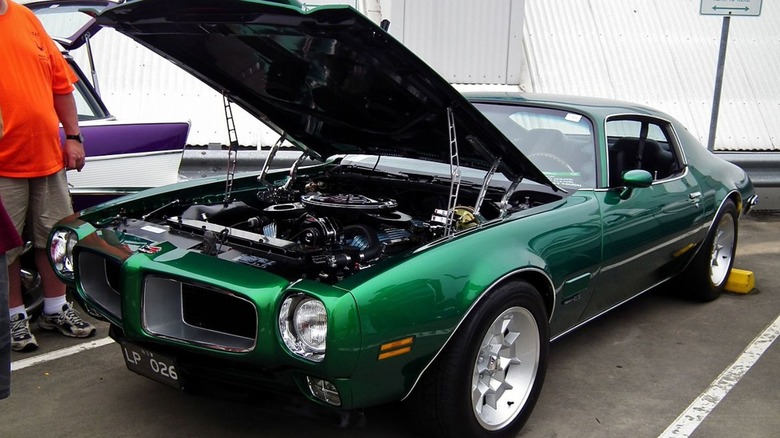 Green Pontiac Firebird with hood open