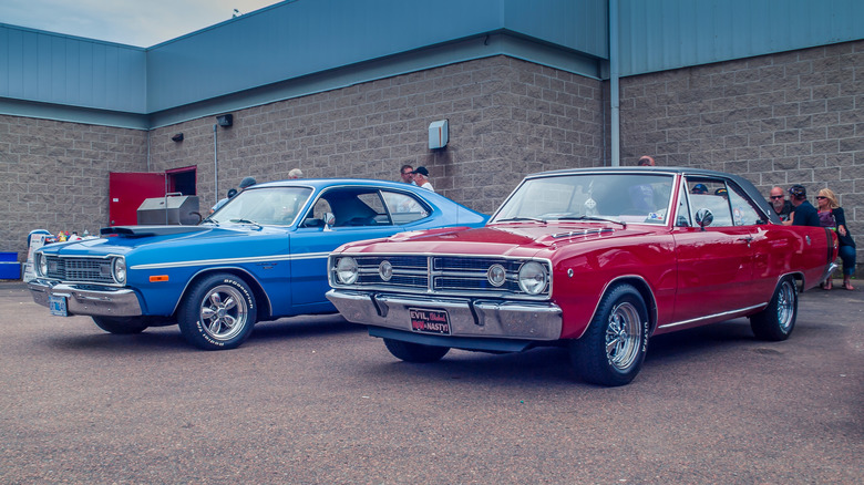 Two dodge darts parked