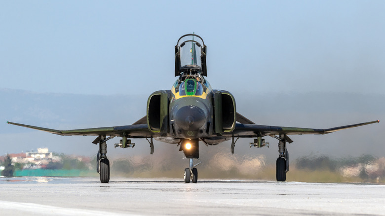 A Hellenic Air Force F-4 Phantom II fighter jet on a runway.