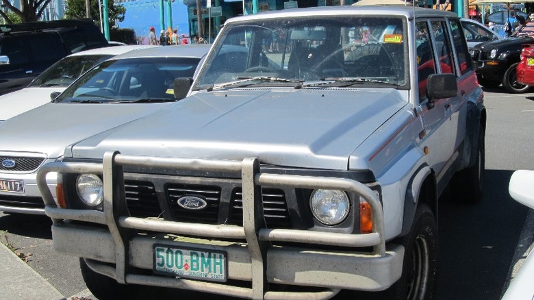 Gray 1990s Ford Maverick SUV parked