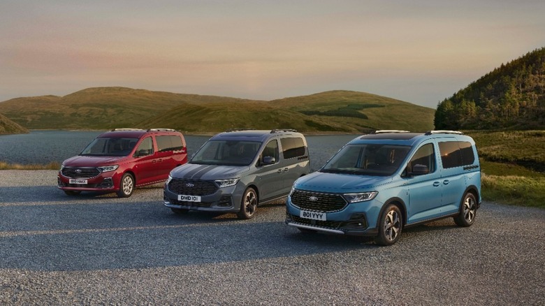 Three Ford Tourneo vans parked by a lake