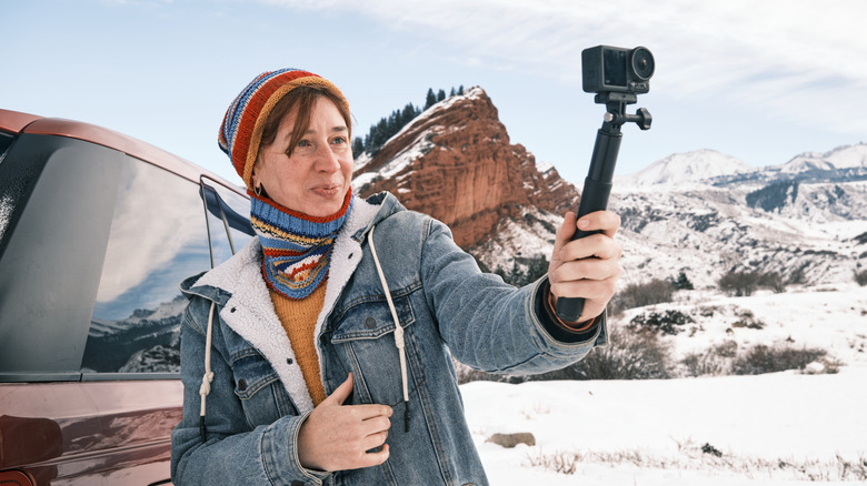 Woman taking photos using an action cam