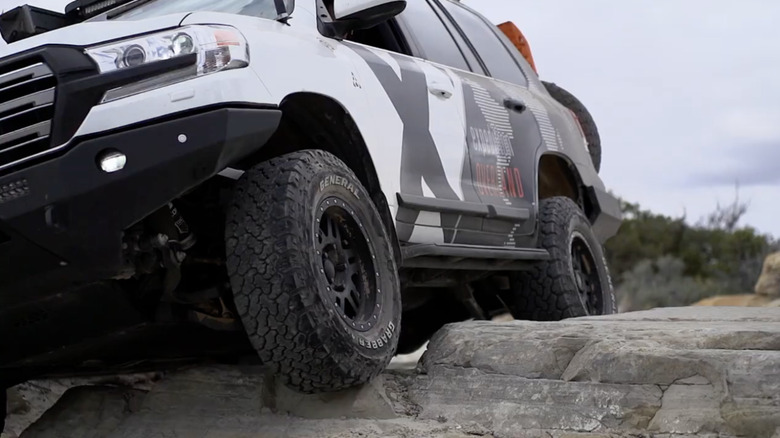 Vehicle drinking over rocks with General all-terrain tires