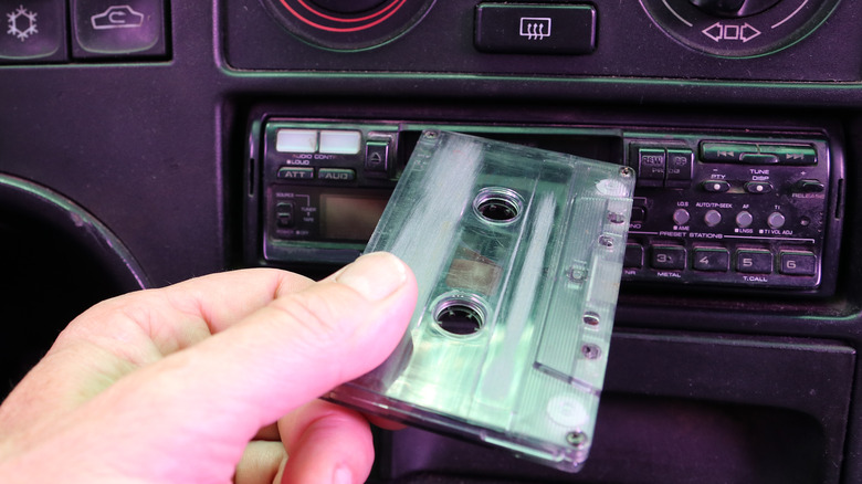 Person inserting cassette tape