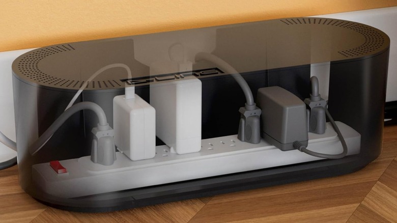 A transparent view of a power strip inside a D-Line cable management box.