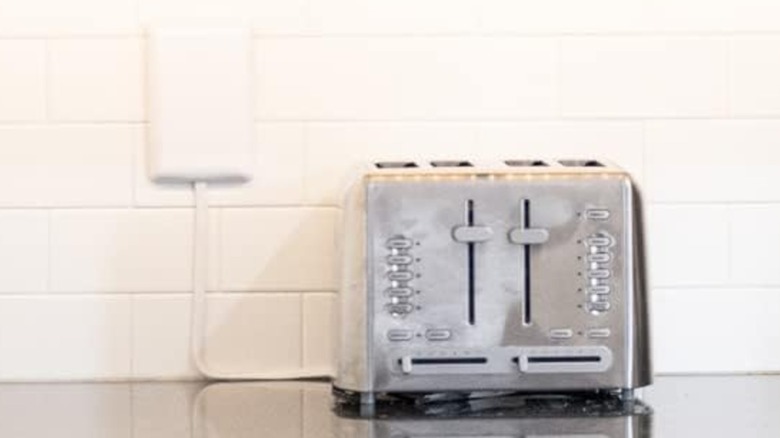 A Sleek Socket outlet concealer on a kitchen counter.