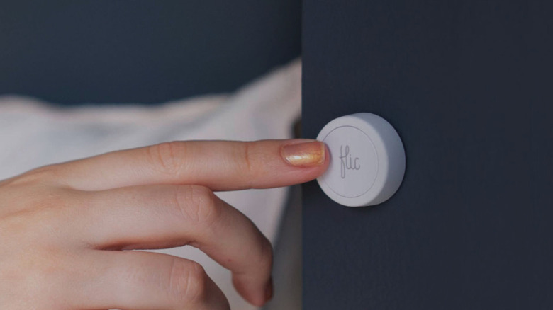 Woman pressing Flic 2 smart button