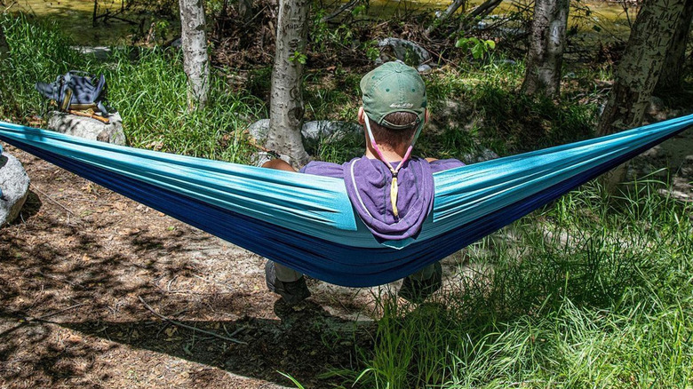 person sitting in hammock