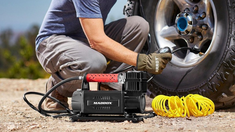 Person filling up tire with inflator