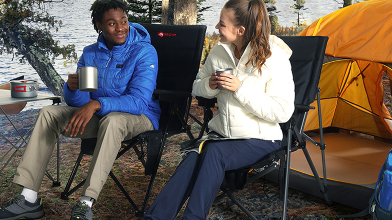 Man and woman sitting in chairs outside