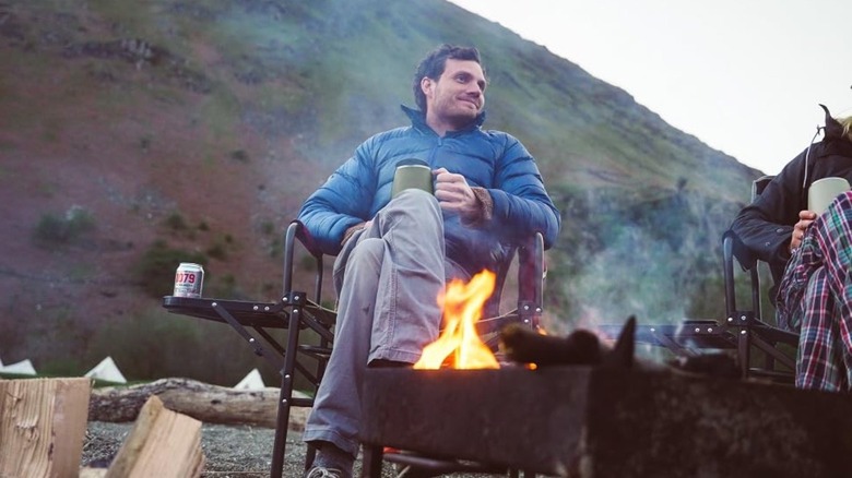 Man sitting in chair outside