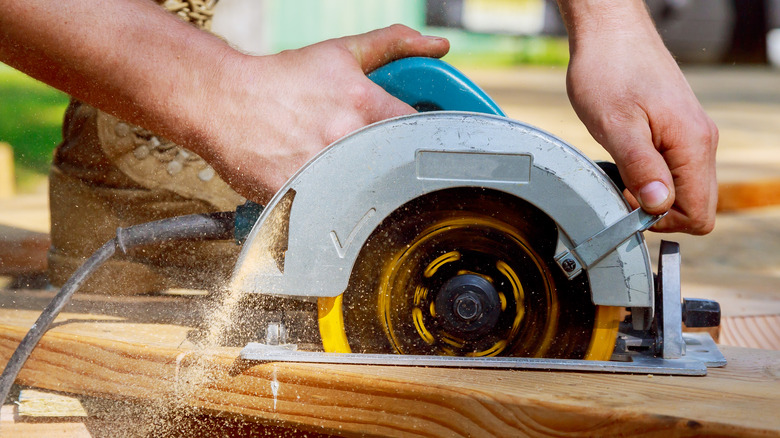 Person using circular saw