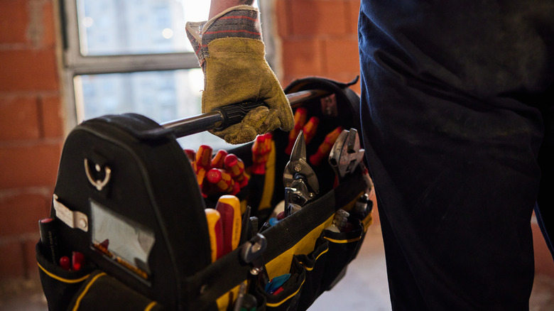 person holding tool box