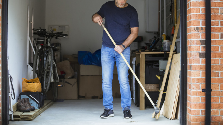 man sweeping the floor