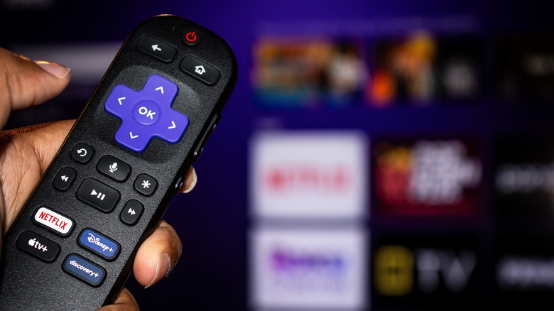 Roku remote in front of tv