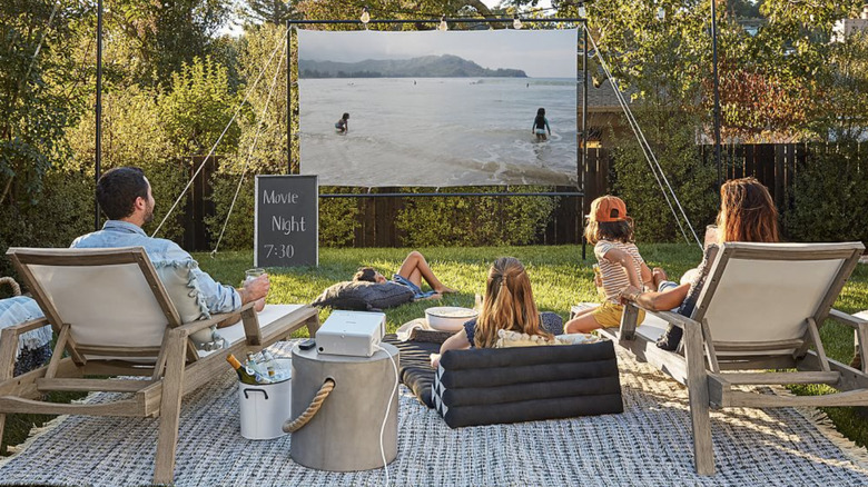 family showing movie with projector