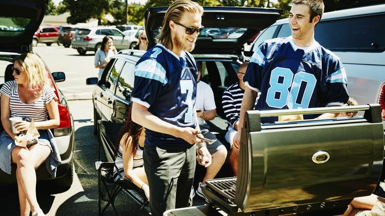 People tailgating cooking food