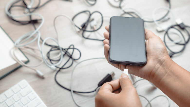 A USB hub in front of many tangled cables