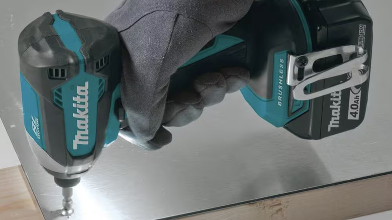 Makita impact driver being used on metal