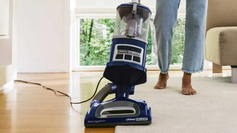 Person vacuuming floors