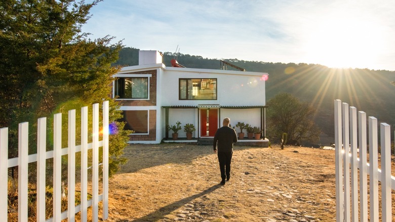 Person walking towards tiny home