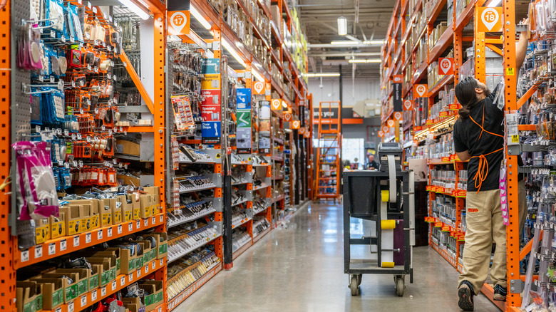 aisle in home depot with worker 