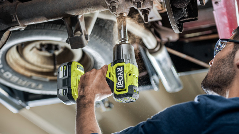 person using Ryobi ½-inch High Torque Impact Wrench on tire