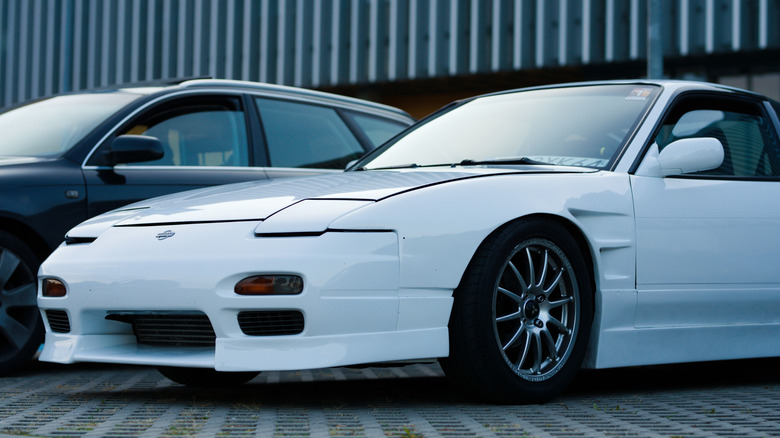 A Nissan S13 240SX white parked on the street