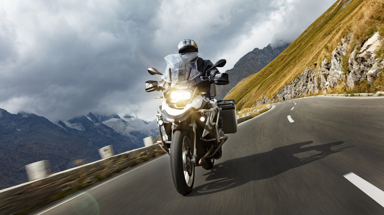 Motorcycle rider on mountain highway