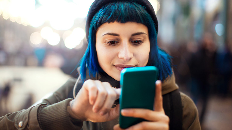 person holding blue smartphone