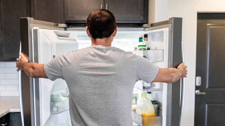 Man opening refrigerator