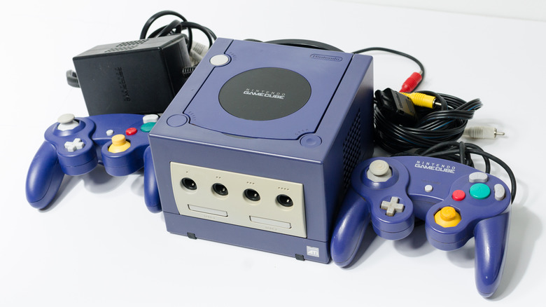 Gamecube console with two controllers on white background