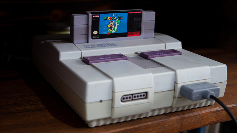 Original SNES console with Super Mario World cartridge inserted