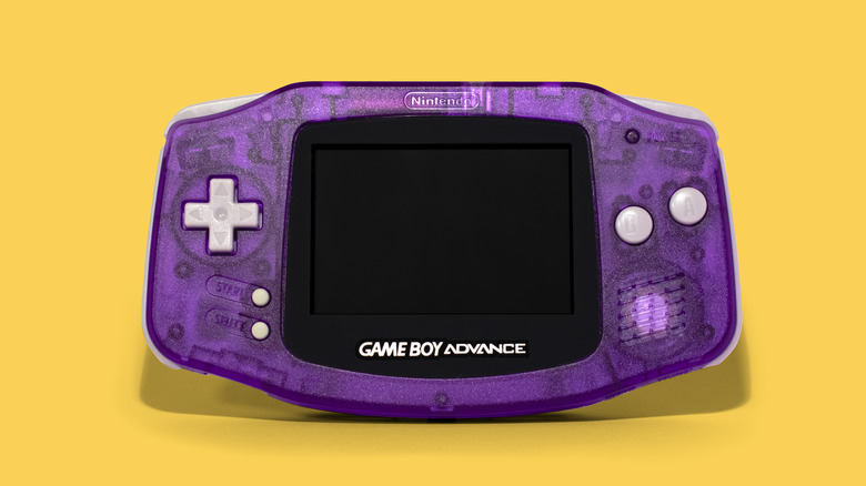 Translucent purple GBA handheld console on yellow background