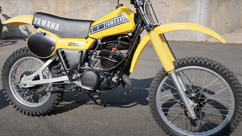 Yamaha YZ250 parked on blacktop in front of grey cement wall