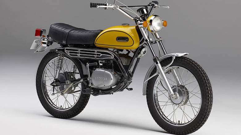 Yellow Yamaha HT-1 motorcycle parked against grey background with shadow underneath