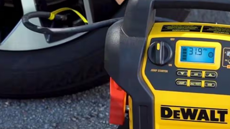 DeWalt jump starter and compressor inflating a tire