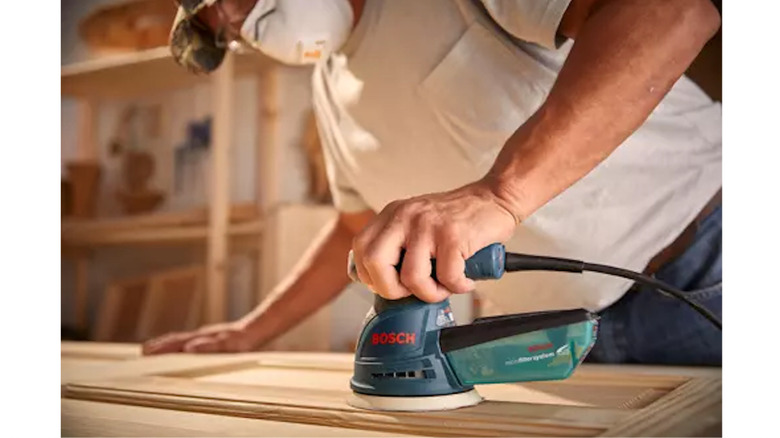 Bosch 120V Random Orbital Sander being used on door