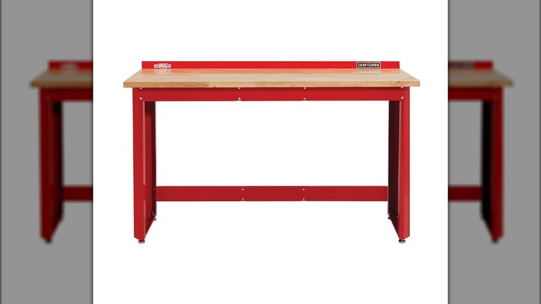 Red Craftsman workbench with wood top