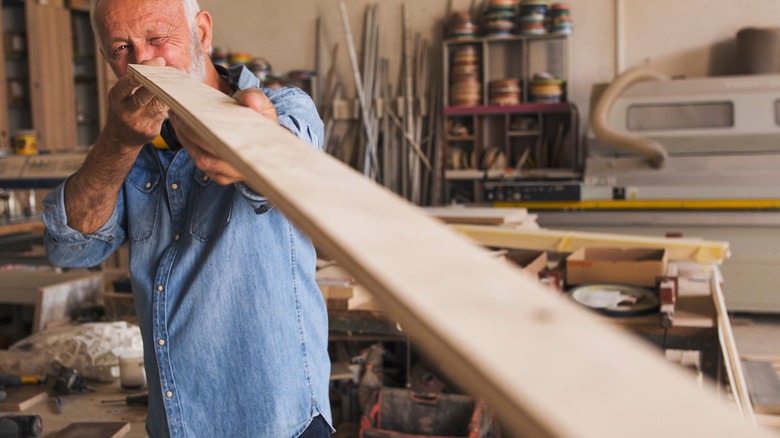 a man inspecting a board