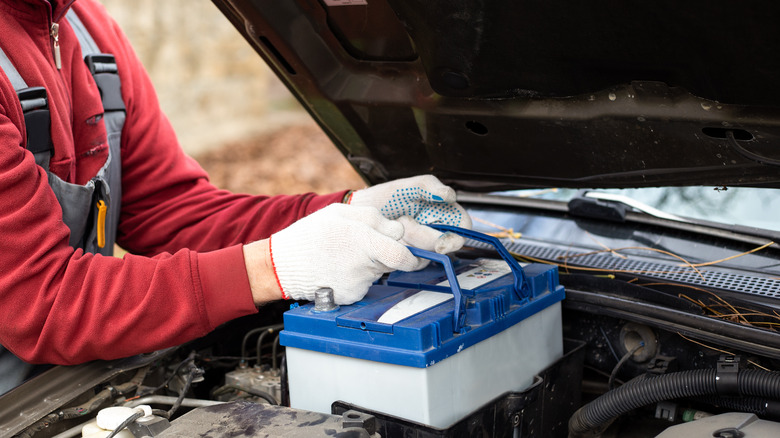 mechanic replacing a car battery