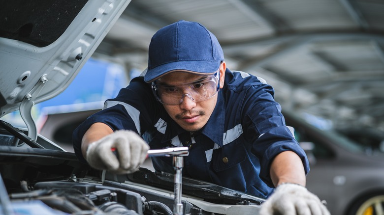 car mechanic inspecting car