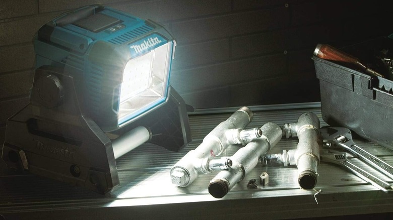 Makita Cordless Work Light shining on pipe fixtures