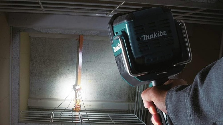 Someone holding a Makita LED Spotlight