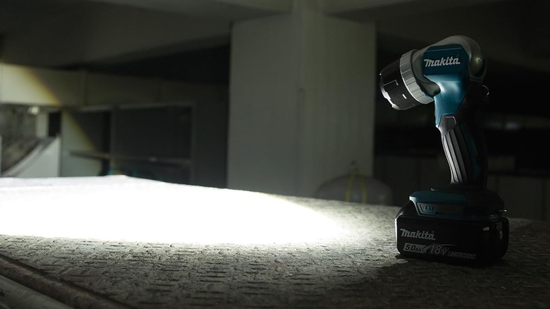 Makita LED flashlight shining on a mattress