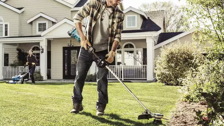 Man using weed eater 